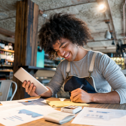 Black business owner paying the bills